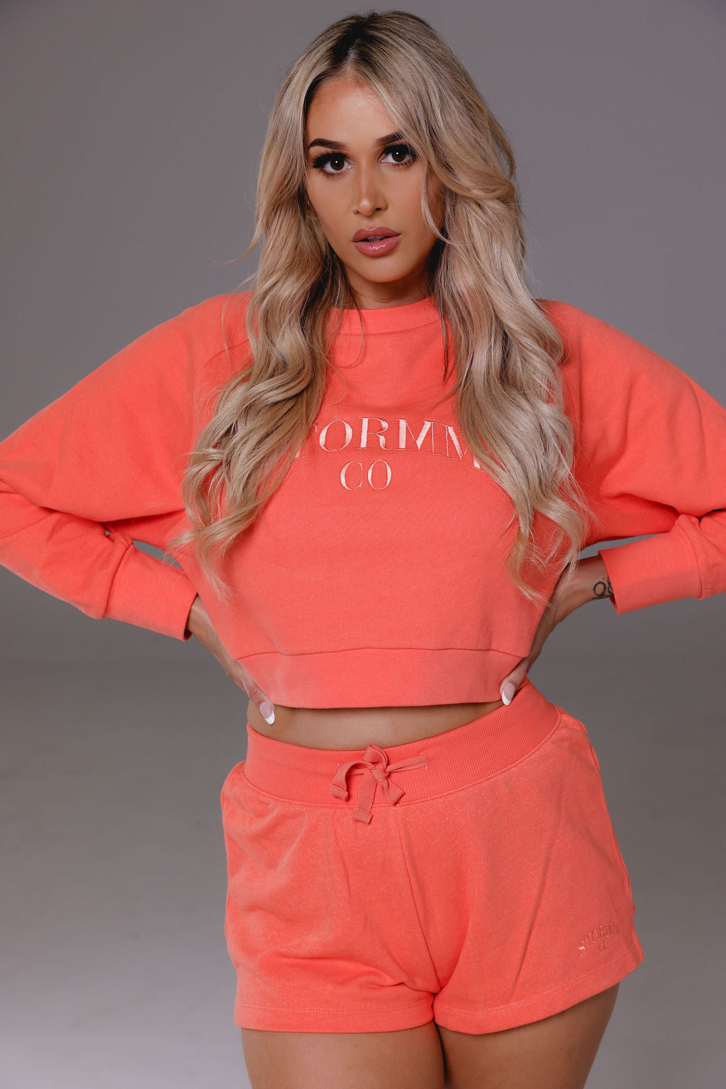 Cropped jumper in coral from Stormm Co's Hues of Happiness collection, made from soft French terry cotton, relaxed fit, and embroidered unique design.
