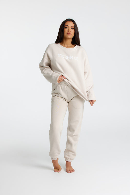 Woman wearing creamy tan jumper from our Soft Touch Collection, showcasing cozy and stylish winter fashion